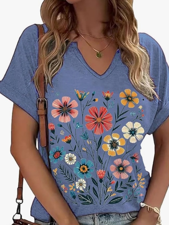 Tops - Soft blue V-neck tee featuring a bold multicolor floral design. Short sleeves an
